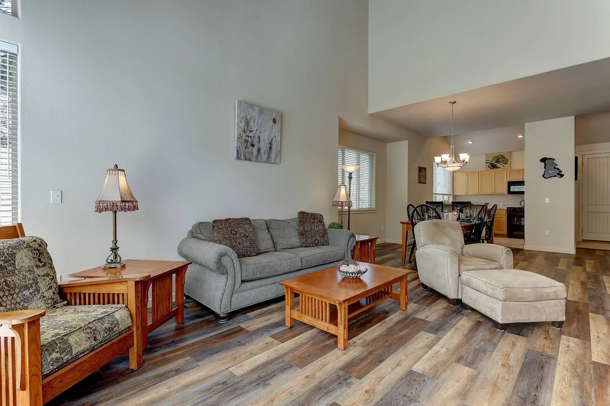 A cozy living area with a comfortable sofa, wooden coffee table, and soft decorative lighting, perfect for relaxing, socializing, or gathering for a movie or board game night.